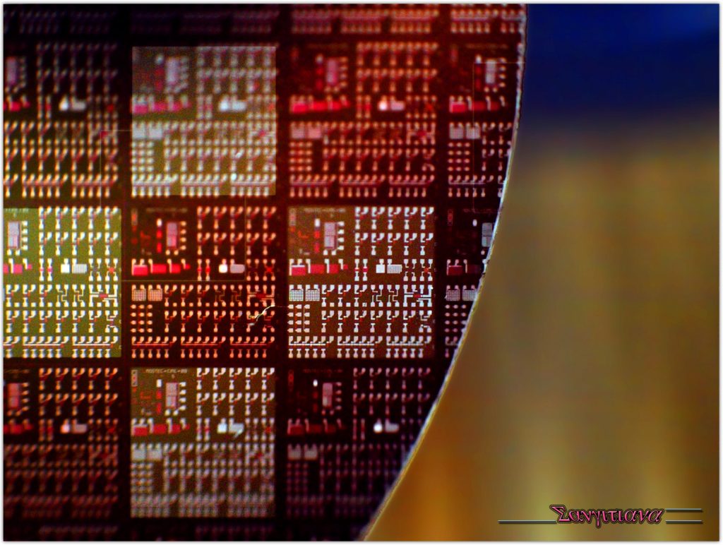 A polished semiconductor silicon wafer held up to the light